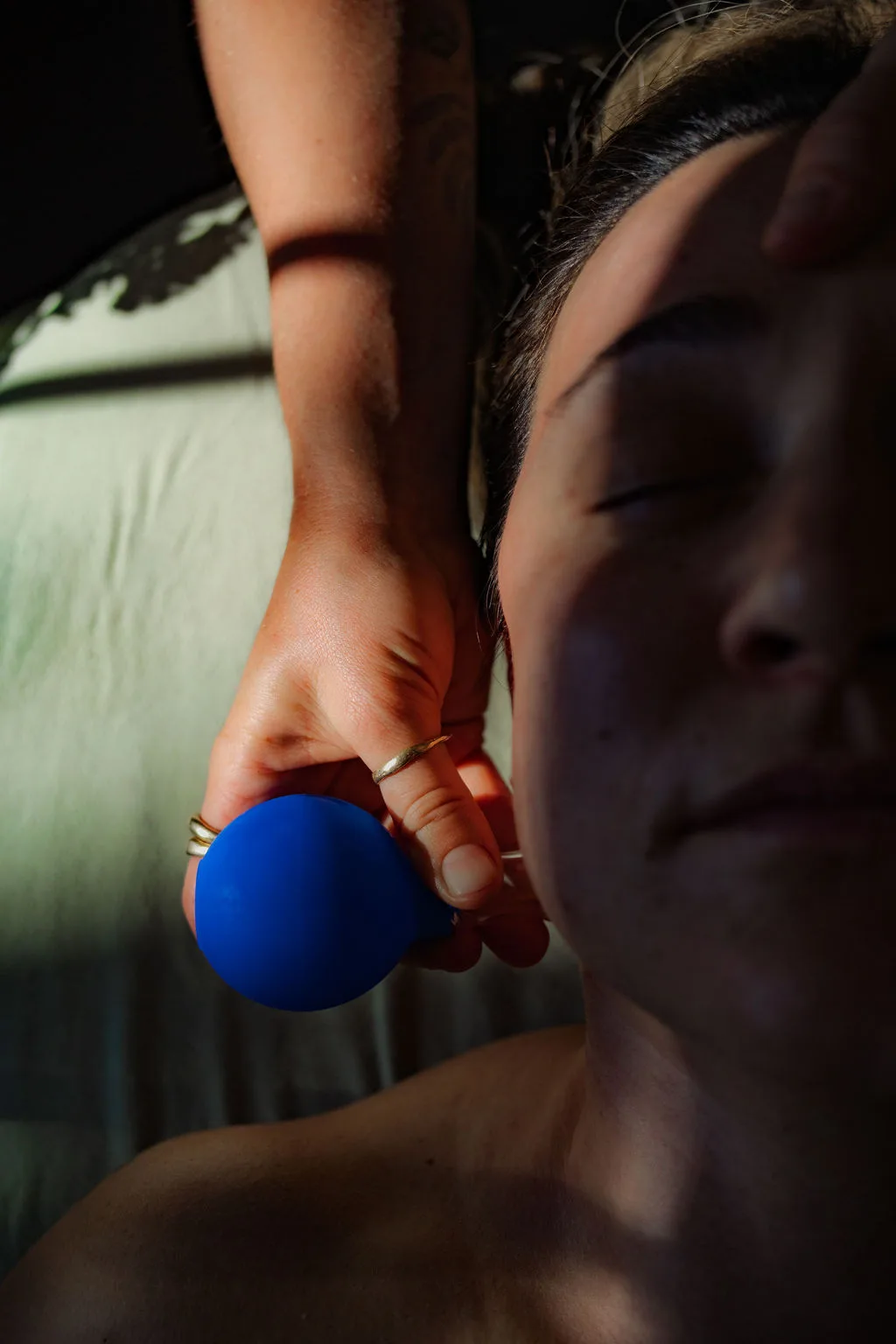 Close-up of Taylar using a facial cup along the cheek