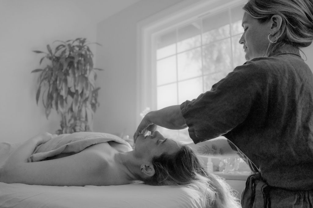 An Evoke practitioner treating a resting patient in a sunlit room